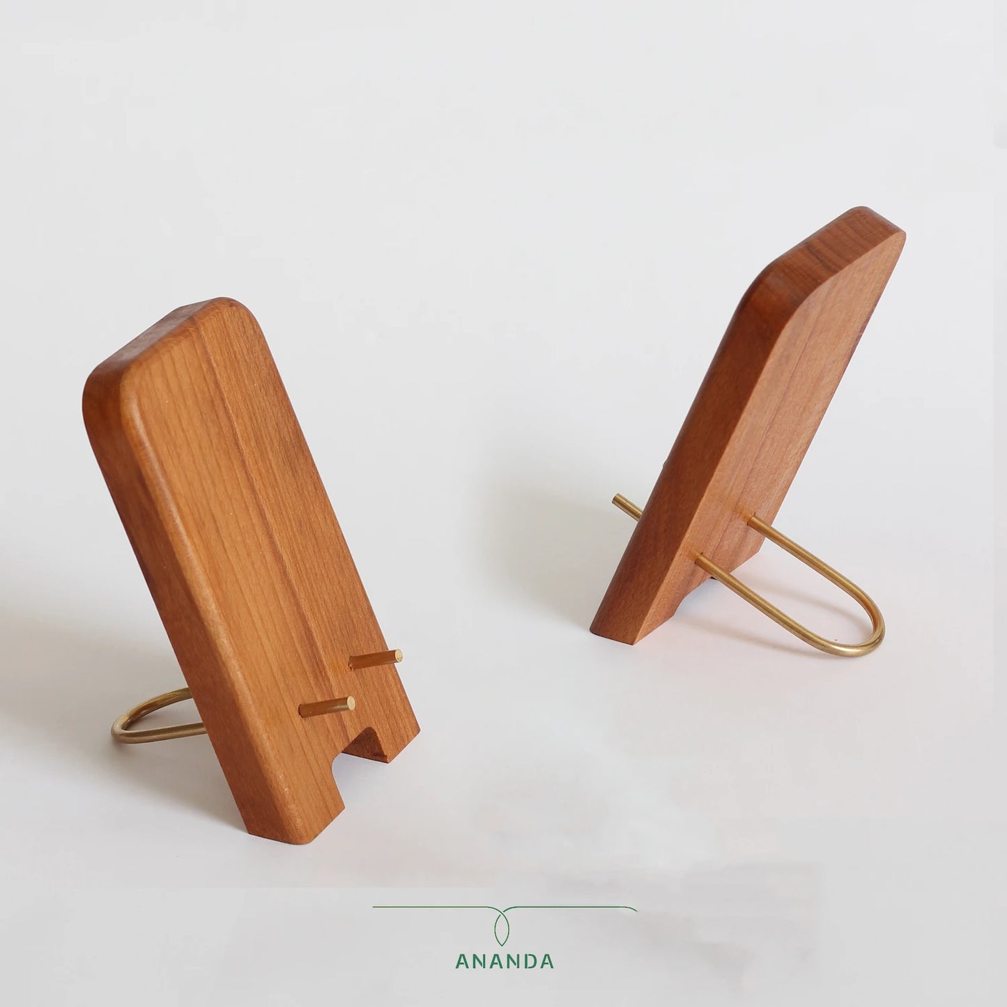 Side-by-side front and back views of the beech wood mobile holder with brass base and cable pass-through slot.