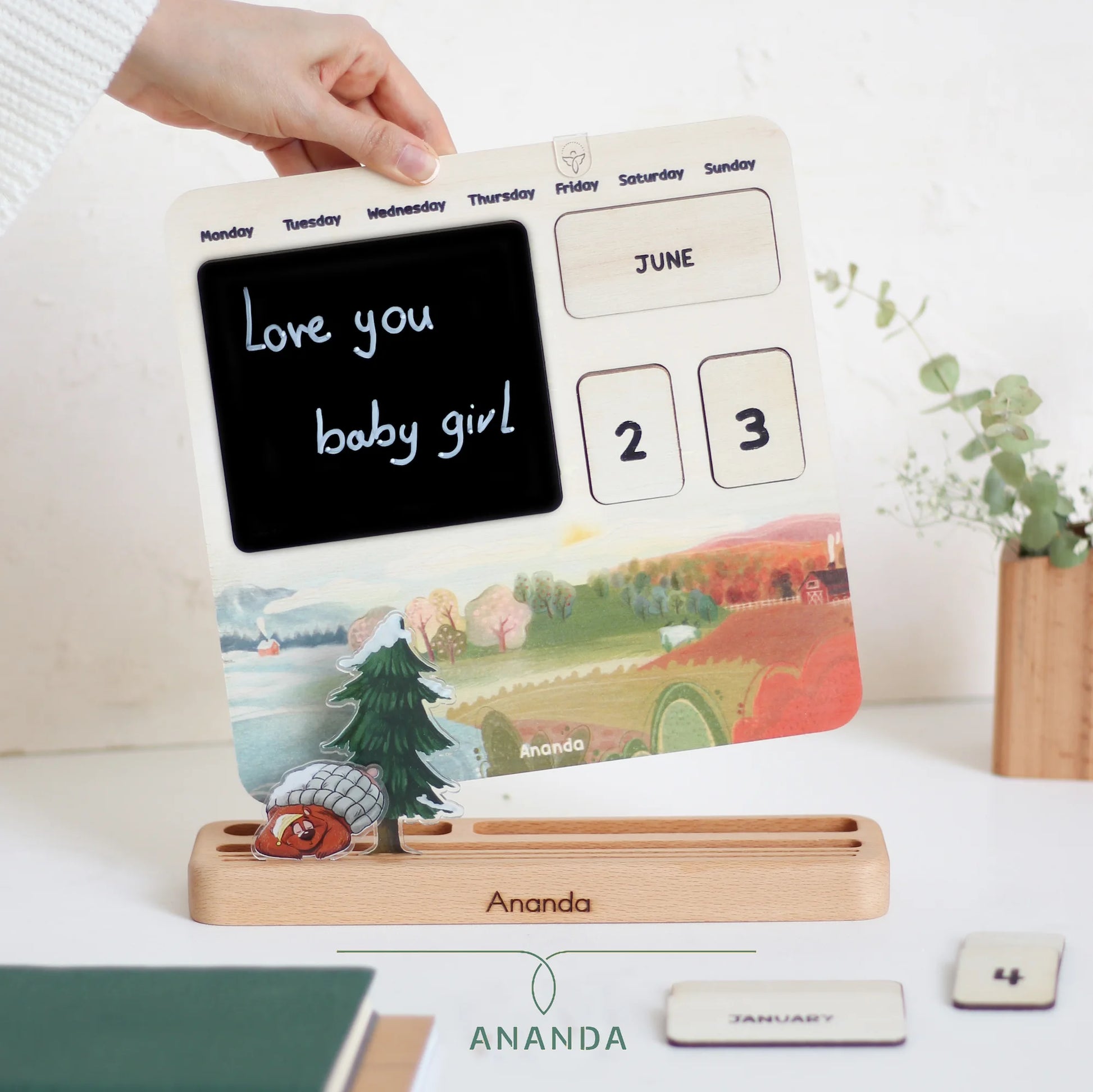The Hannah perpetual calendar displayed on a beech wood base, with a 3D-style bear character adding a playful touch to the design.