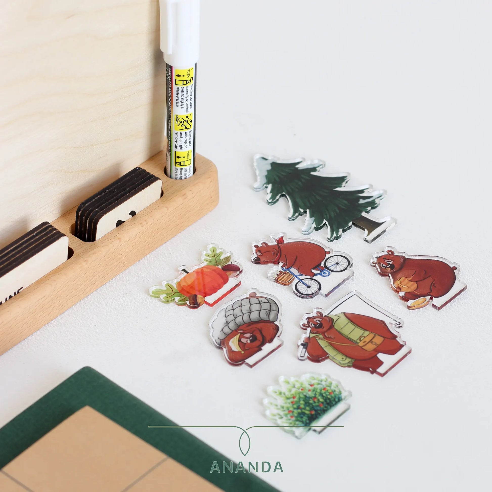 The set of playful bear characters, designed and laser-cut from clear plexiglass, neatly arranged in front of the Hannah calendar. These whimsical characters, each representing a season or activity, add charm and personalization to the calendar, allowing users to customize their display for each time of year.