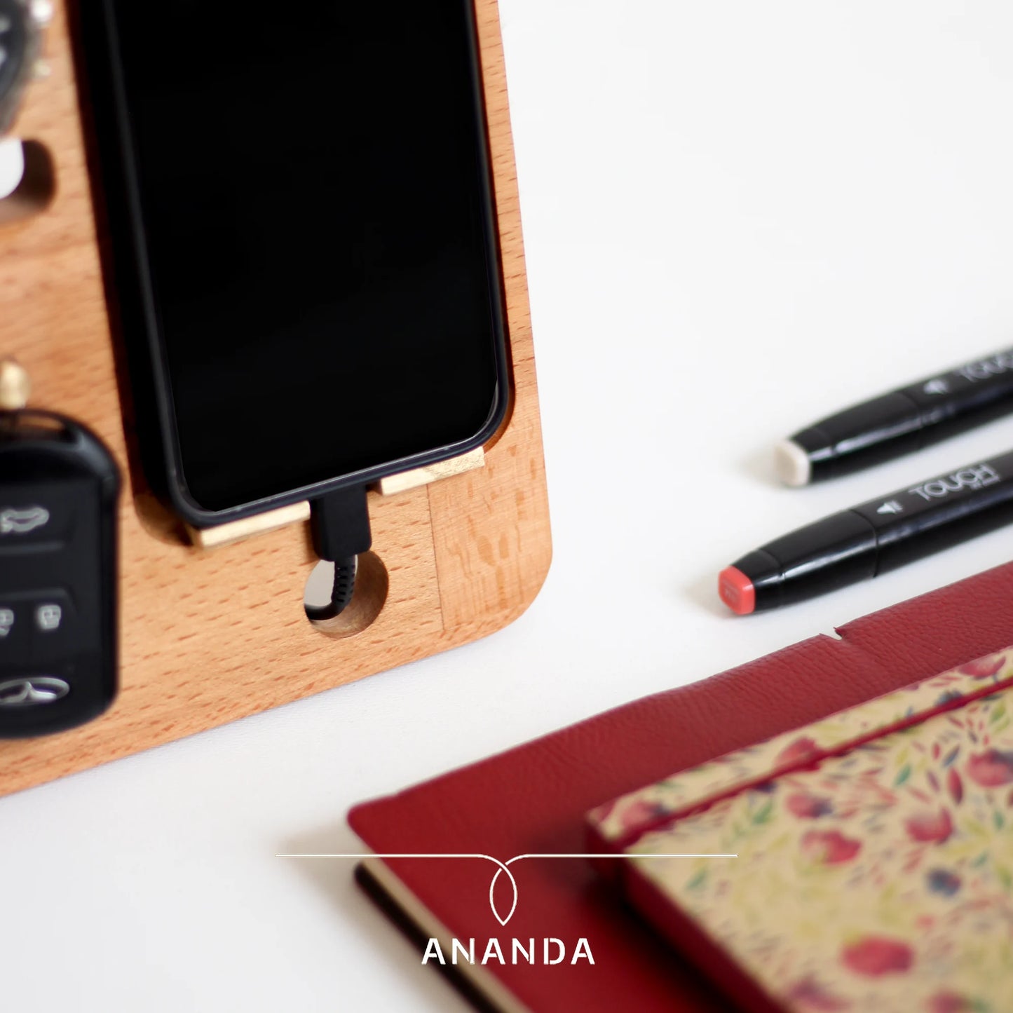Close-up of phone dock with charging port and carved tray